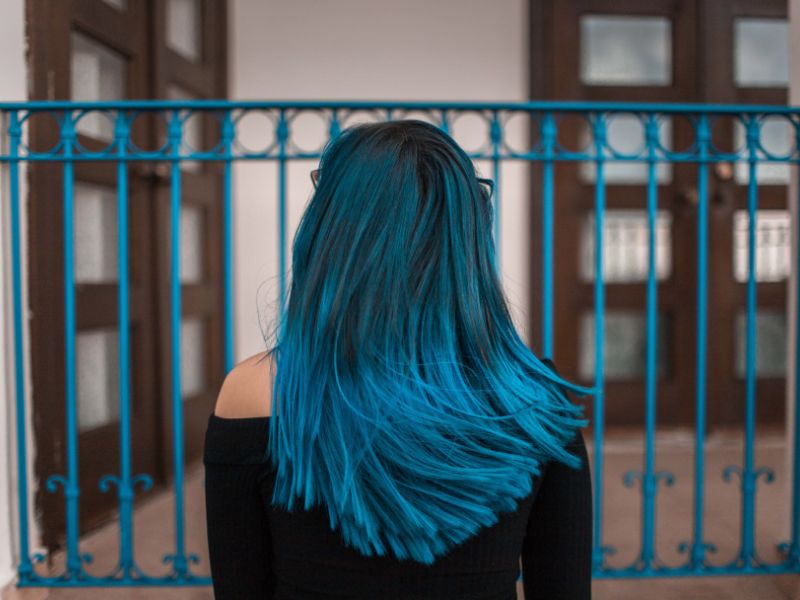 A back view of a woman with color treated hair