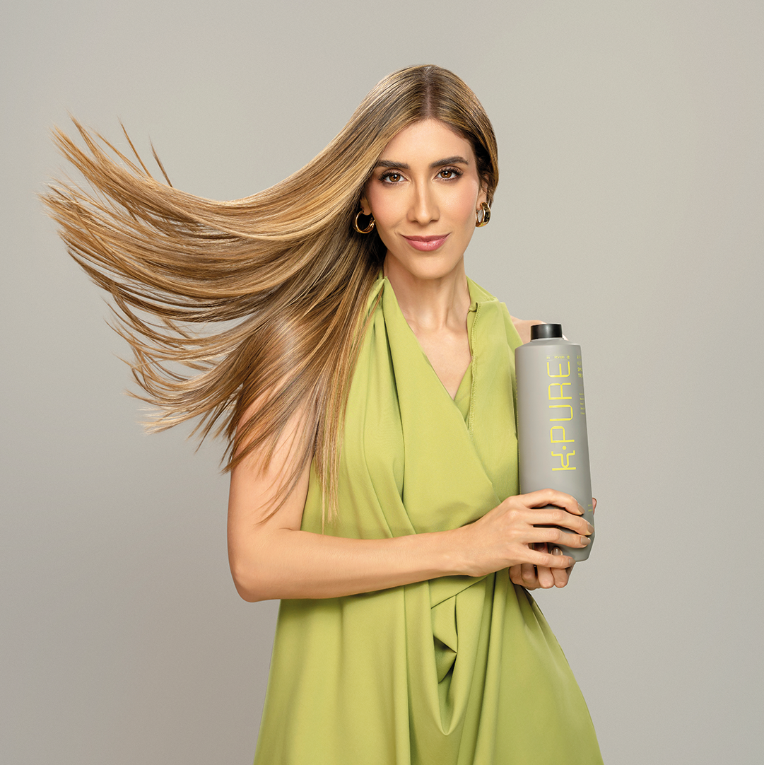 A blonde hair woman promoting hair products from Kpure