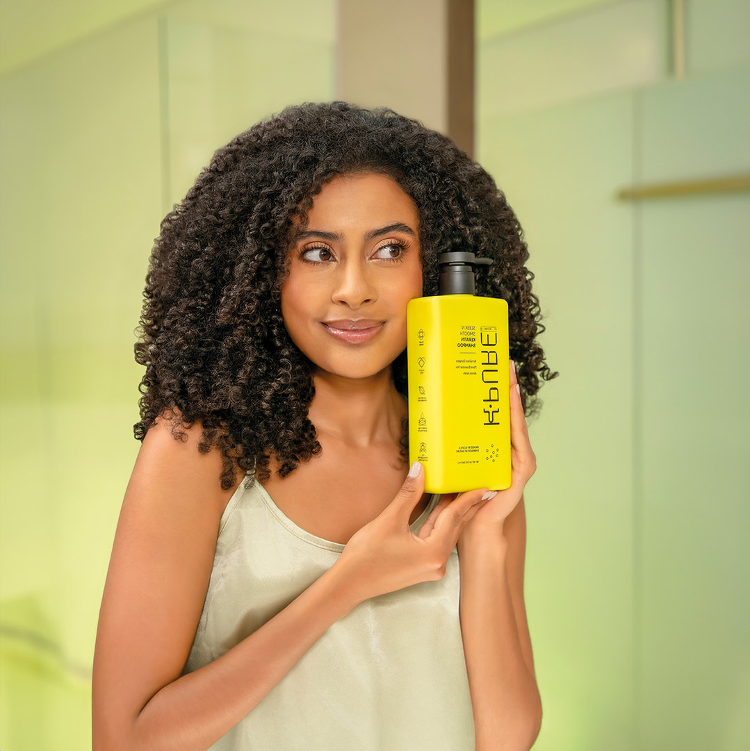 A women holding Kpure sleek n' smooth keratin shampoo