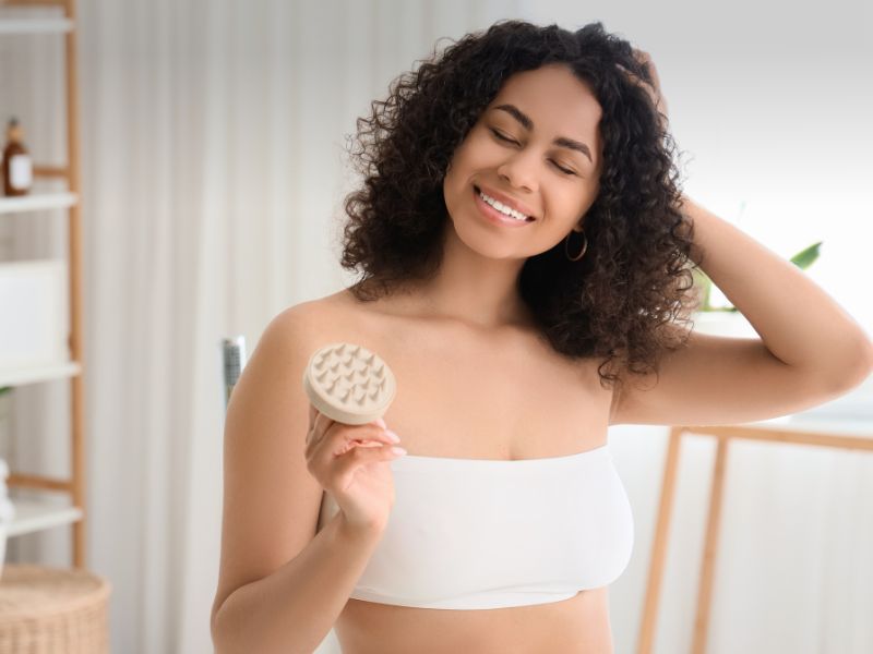 Beautiful Young Happy Woman with Hair Scalp Massager in Bathroom
