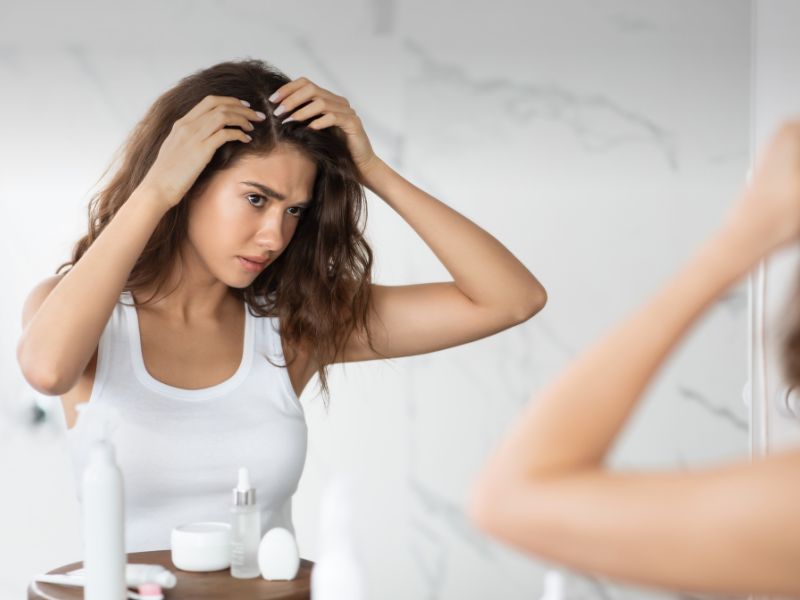Frustrated Lady Searching Hair Flakes Suffering from Dandruff Problem Indoors